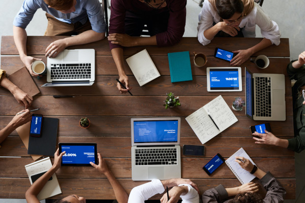 people sitting at the table with devices